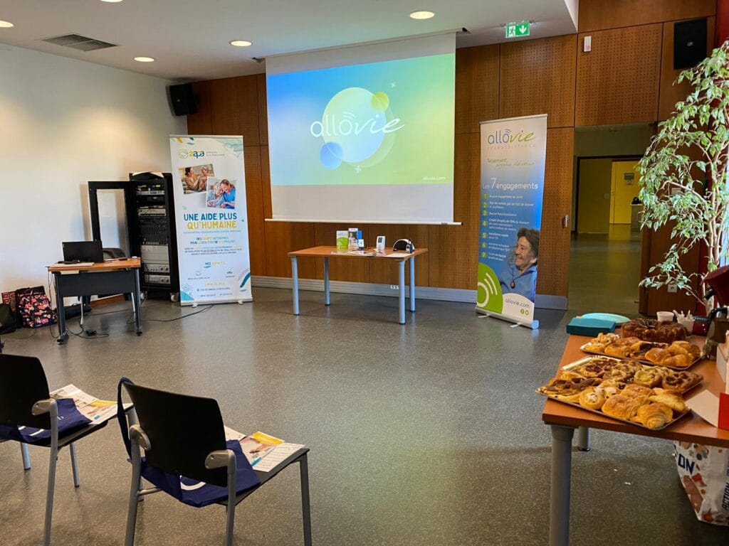 Salle de conférence avec présentations et buffet de viennoiseries.