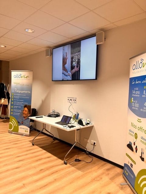 Salle de présentation avec écrans et supports promotionnels.