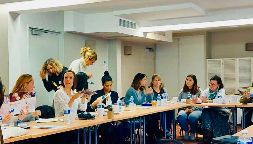 Réunion de travail avec plusieurs participantes en discussion.