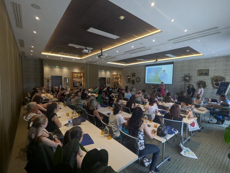 Conférence en salle avec participants assis.